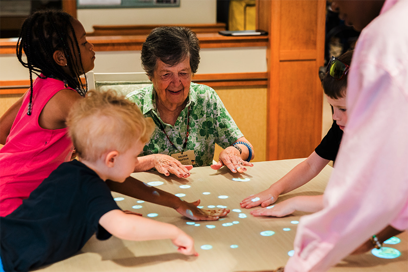 Senior living resident engages with students